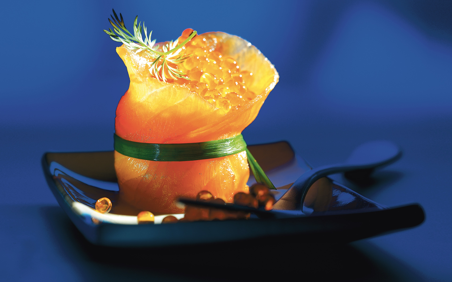 Geräucherter Lachs mit Lachskaviar auf dunklem Teller